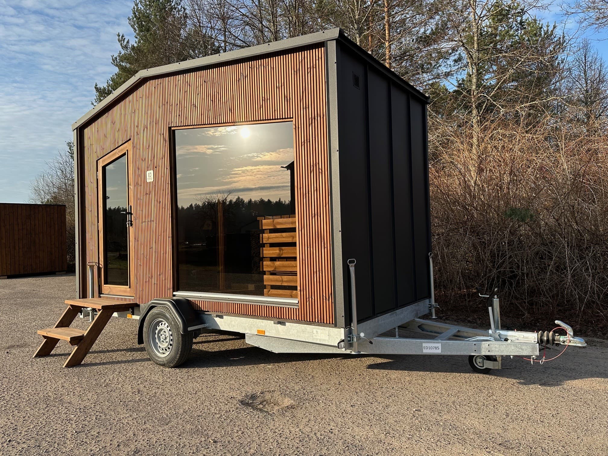 A modern cube mobile sauna trailer with vertical timber cladding, the kind of unit a hire business operates
